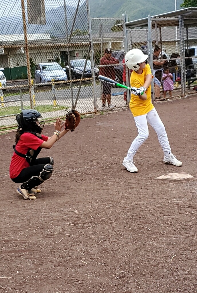 Photo of catcher and batter swinging at a pitch