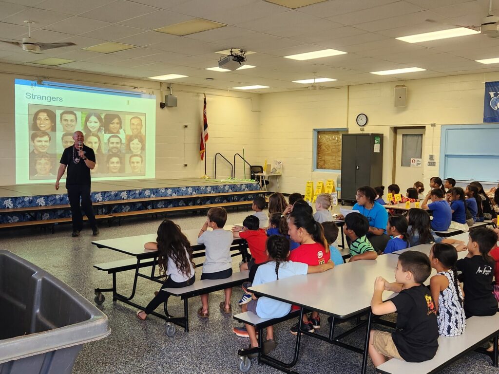 Officers giving stranger danger presentations to students at Wahiawa Elementary.