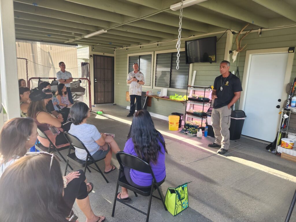 Officers presenting information to a neighborhood security watch