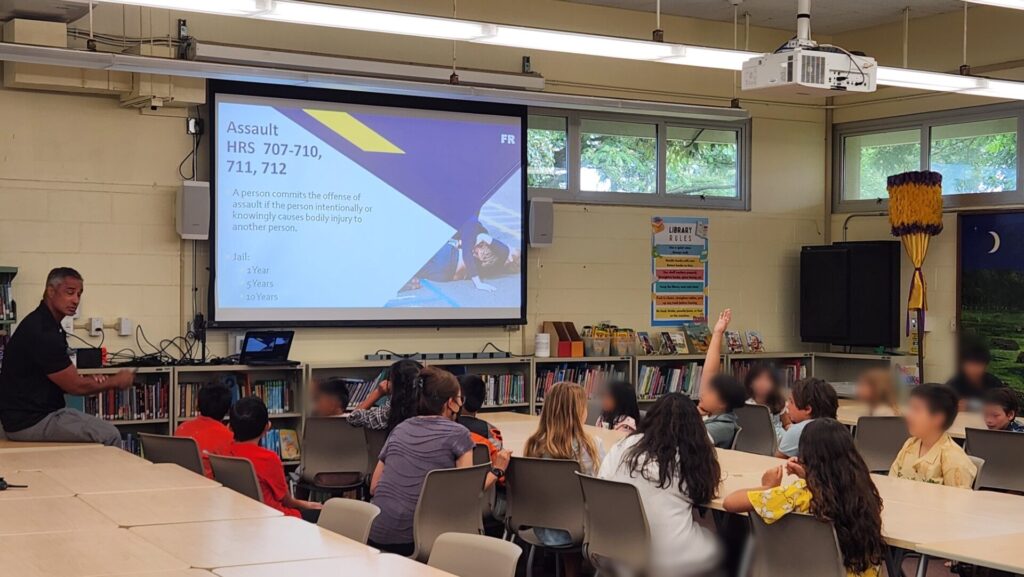 Officers doing a presentation on bullying to students