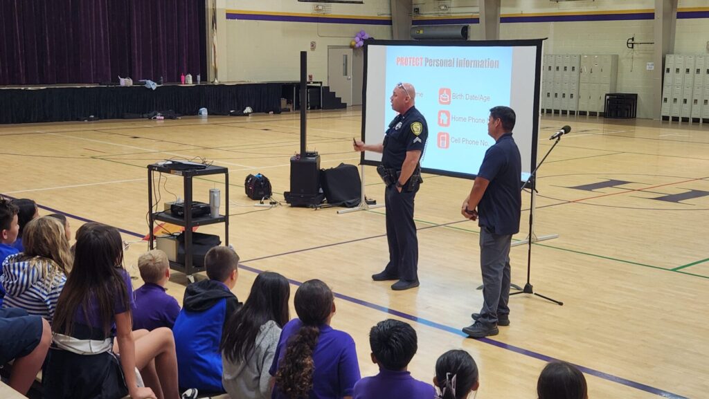 Officers doing an internet safety presentation at Hanalani School