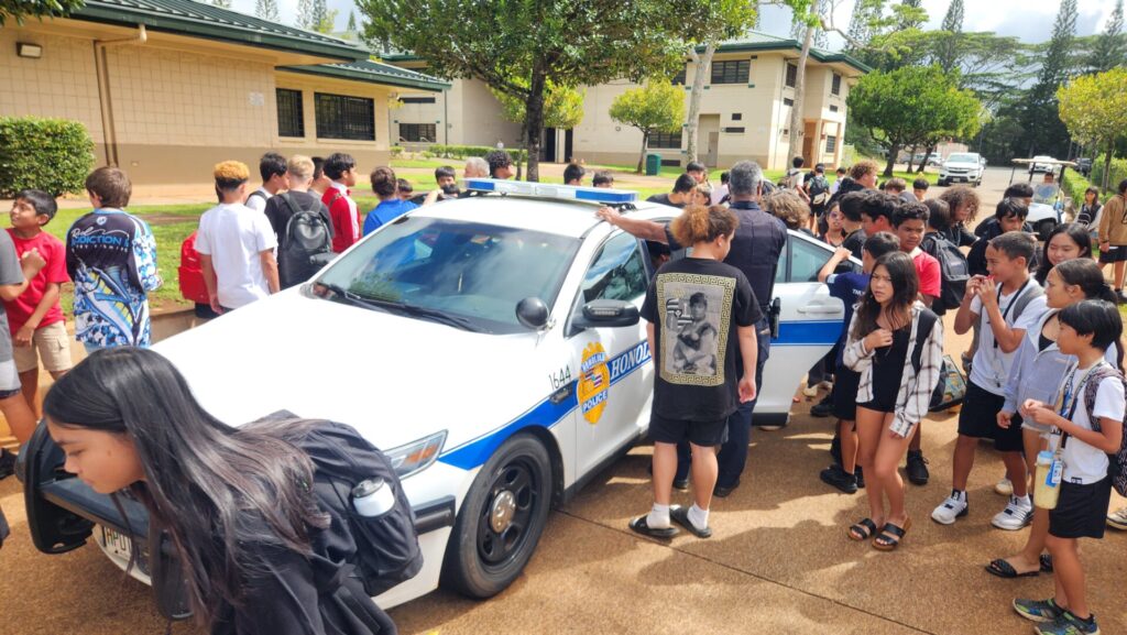 Officers showing students the police vehicle