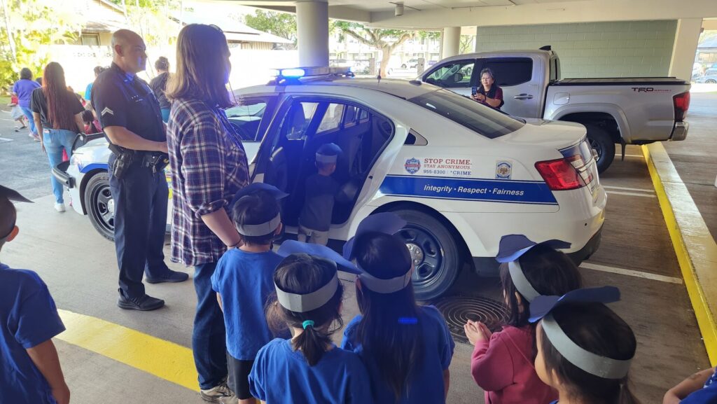 Officers showing the police vehicle to the students