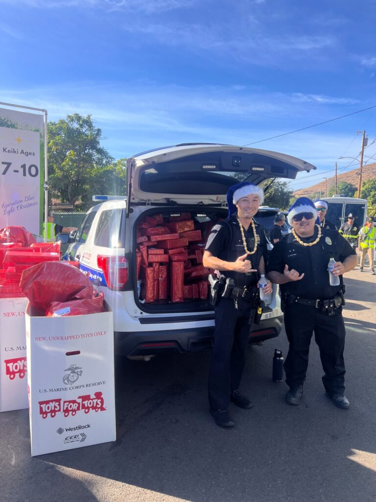 D8 CPT officers standing in front of HPD blue and white getting ready to pass out gifts at Operation Blue light Christmas