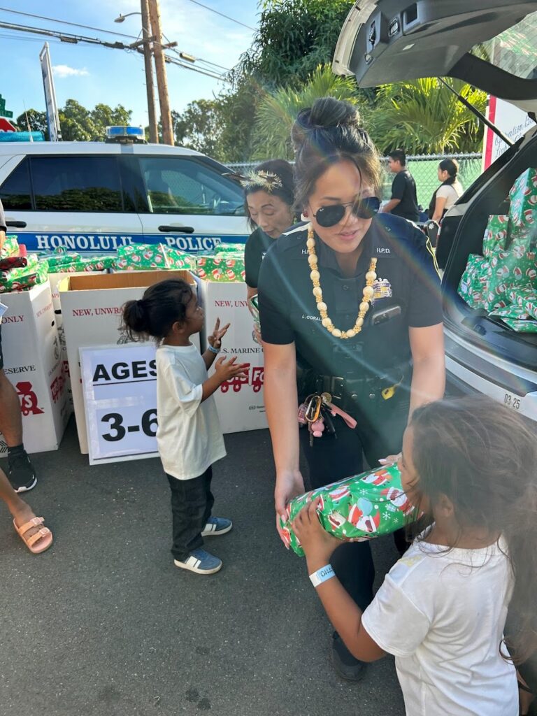 CPT Officer Corales passing out gifts to participants at Operation Blue Light Christmas