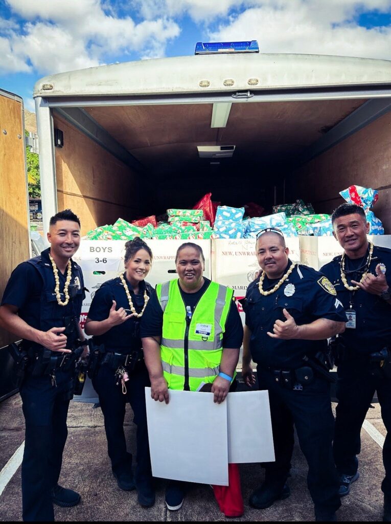 Members of CPT Team with volunteer packing up the presents to hand out for Operation Blue Light Christmas